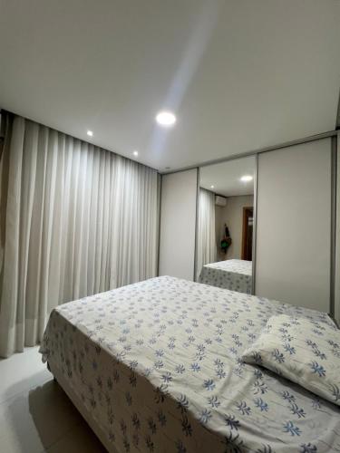 a bedroom with a large bed and a mirror at Casa aconchegante in Imperatriz