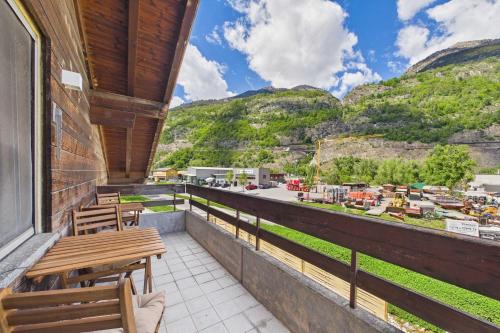 a balcony with benches and a view of mountains at Spacious apartment in Brig-Glis in Gamsen