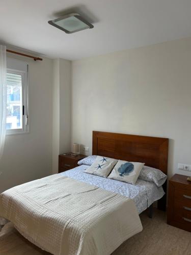 a bedroom with a bed with two pillows on it at Apartamento Mar Blava Chilches in Chilches