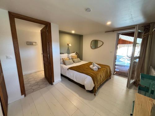a bedroom with a bed with a teddy bear on it at Gite Authentique Évasion in Saint-Mard-de-Vaux