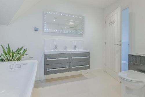 a white bathroom with a sink and a toilet at 5 Bed in Hereford oc-78646 in Madley