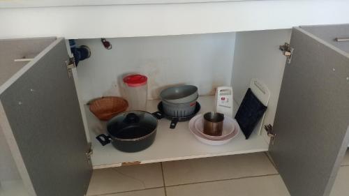 ein Schrank mit einigen Töpfen und Pfannen darin in der Unterkunft Boulevard Roca in Trelew