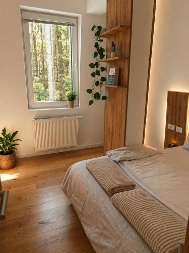 a bedroom with a bed and a window at Oaza in Bjelašnica
