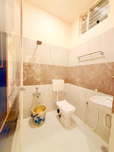 a bathroom with a toilet and a sink at HARI HARA HOMEs in Rāmeswaram