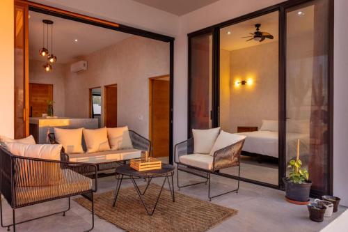 a living room with a couch and a bed at Sun-drenched escape w sleek saltwater pool in Todos Santos