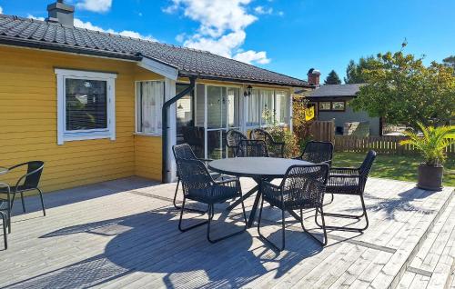a patio with a table and chairs in front of a house at 3 Bedroom Awesome Home In Sölvesborg in Sölvesborg