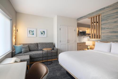 a hotel room with a bed and a couch at TownePlace Suites by Marriott Hickory in Hickory