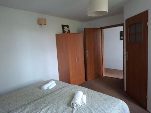 a bedroom with a bed with two towels on it at Mazury Villa Ecomfort in Szeligi