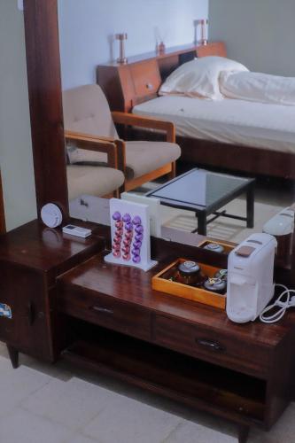 a bedroom with a bed and a table with a mirror at Atlasio House in Kasri