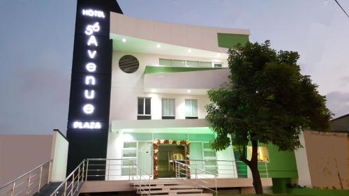 a large white building with a sign on it at Hotel 56 Avenue Plaza in Barranquilla