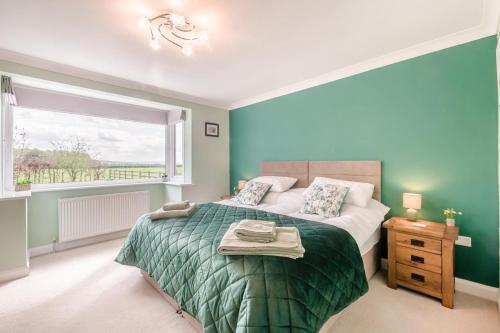 a bedroom with a large bed and a window at 3 Bed in Ebberston oc-s35053 in Ebberston