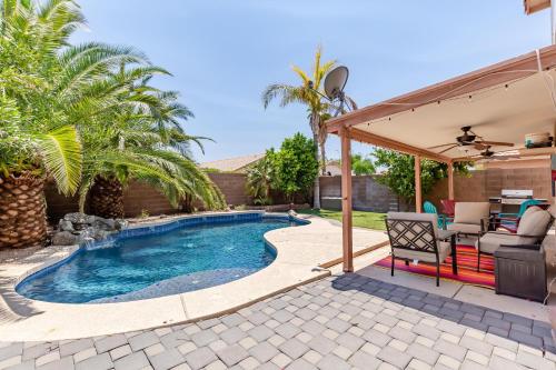 a swimming pool with a pergola and a patio at Chandler Oasis in Chandler