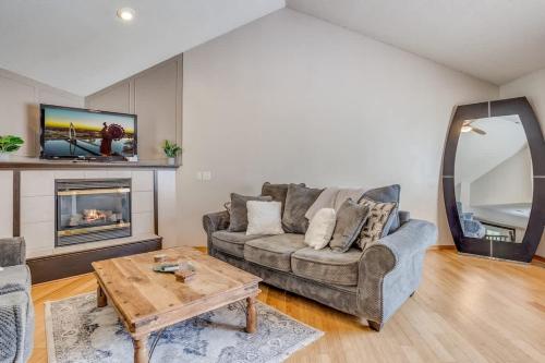 a living room with a couch and a fireplace at The KANtucky Derby Home in Derby