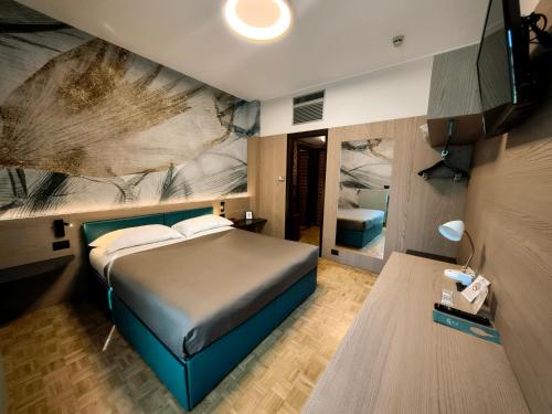 a bedroom with a bed with a painting on the wall at Park Hotel Meublé in Como