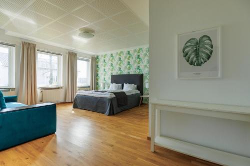 a bedroom with a bed and a couch at Hensbacka Hotell in Munkedal
