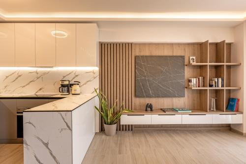 a kitchen with marble countertops and a counter top at Riviera Zen apartment in Mesochórion