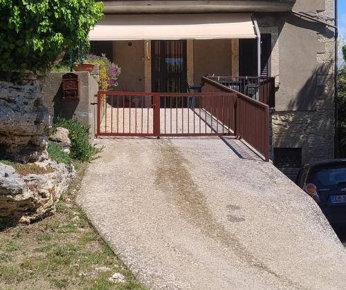 a driveway with a gate in front of a house at Casa Bonaccorsi in Civitella Del Lago