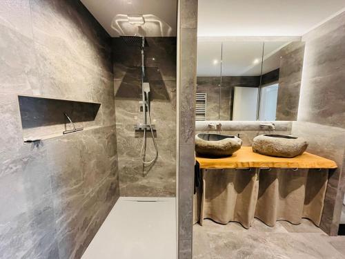 a bathroom with two sinks and a shower at Modern haven with garden in Marignier