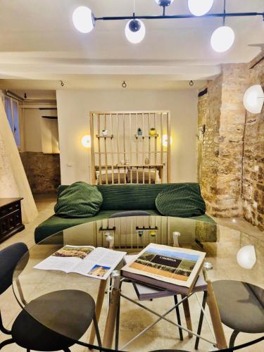 a living room with a green couch and a table at Loft in Love in Spello