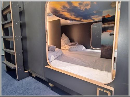 a bedroom with two beds in a small room at Fabcap Kapsel Apartment in Halle an der Saale