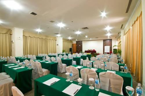 a room with green and white tables and chairs at Golden View Hotel in Nagoya