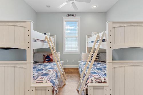 a room with two bunk beds and a window at Sea La Vie , Walk Everywhere in Rosemary Beach