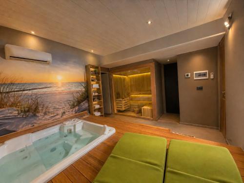 a jacuzzi tub in a room with a beach at Villa Irabo in Albenga