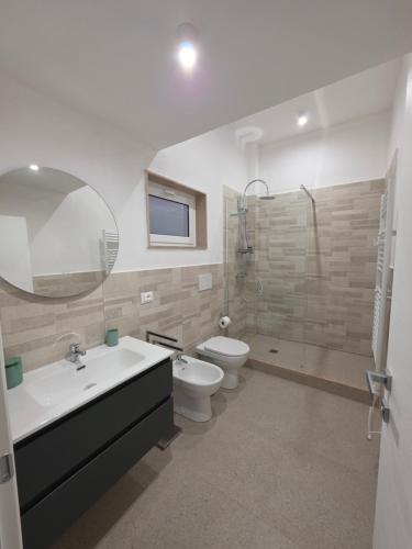 a bathroom with a sink and a toilet and a shower at Piccola Chappy in Taranto