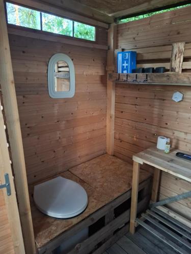 a toilet in the inside of a wooden cabin at Glamping Dübener Heide in Bad Schmiedeberg