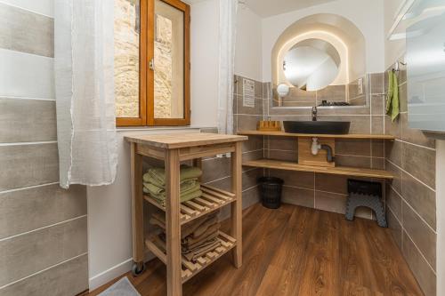 a bathroom with a sink and a mirror at Au Château de Villelongue B&B in Villelongue-dʼAude