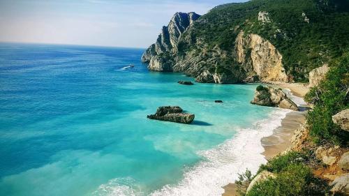 an aerial view of a beach next to the ocean at Sesimbra Horizon in Sesimbra