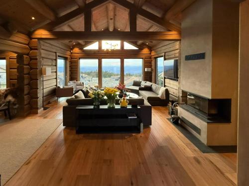 a large living room with a couch and a fireplace at Luxurious Log Cabin At Mostertoppen in Øyer