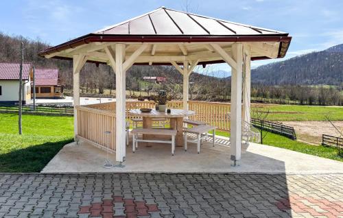 a wooden gazebo with a table and bench at Gorgeous Home In Buzim in Bužim