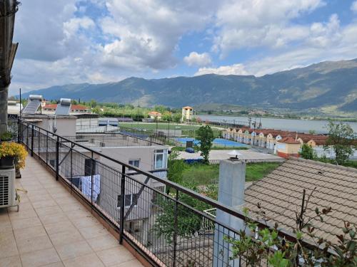 a balcony with a view of a river and mountains at Melis House - Lake View, 75'' TV Live Football, Free Parking in Ioannina