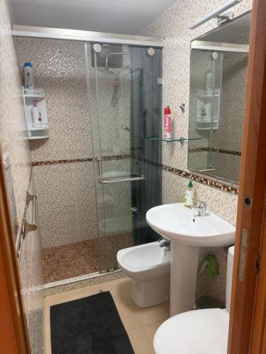 a bathroom with a shower and a toilet and a sink at Apartamento nora in Ceuta