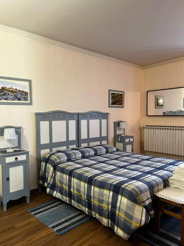 a bedroom with a blue and yellow bed and a table at I Quattro Grappoli in Neive