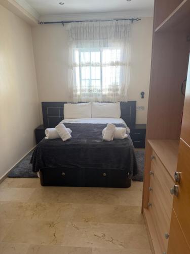 a bedroom with a bed with two towels on it at Apartamento nora in Ceuta