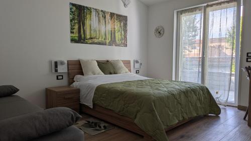 a bedroom with a large bed and a couch at AURA MARINA - Guest House Fiumicino in Fiumicino
