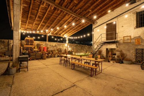 a group of tables and chairs in a building with lights at Dimora Perla di Villa - Spacious Wine Estate Retreat near Bernina Express in Villa di Tirano