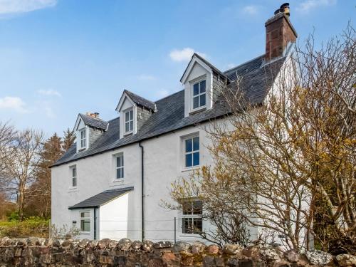 a white house with a black roof at Seafield House in Lochinver