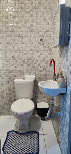 a bathroom with a toilet and a sink at Mini Apartamentos na entrada de Tutóia in Tutóia