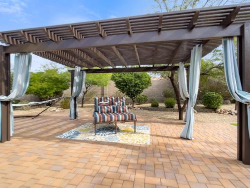 a group of chairs sitting under a pergola at Anthem Allure in Phoenix