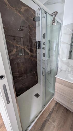 a bathroom with a shower and a sink at AURA MARINA - Guest House Fiumicino in Fiumicino
