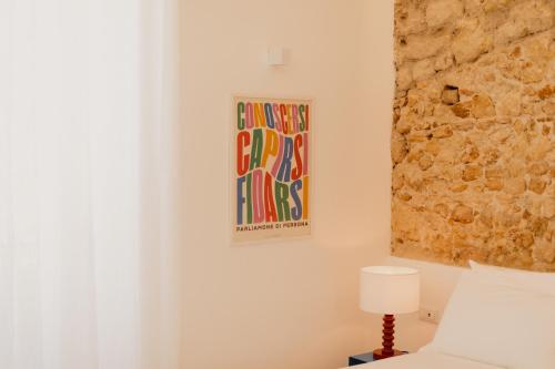 a bedroom with a bed and a painting on the wall at Andrew suites in Nettuno