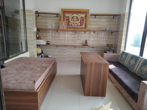 a living room with a couch and a table at Hotel Murlidhar in Chikāra