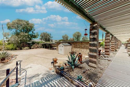 a brick house with a patio and a yard at Tranquil Trail #8 in Carefree