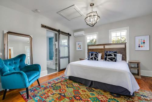 a bedroom with a bed and a blue chair at Historic Downtown Marble Falls- 2 Suite Combo 13 in Marble Falls