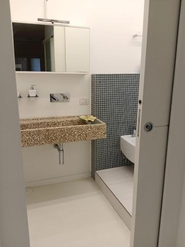 a bathroom with a sink and a mirror at White Stylish Apartment 4 in Vico Equense