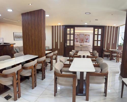 a restaurant with tables and chairs in a room at Elysee Residence in Beirut