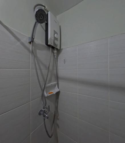a shower in a bathroom with a shower head at Mivesa Garden Residences Lahug in Cebu City